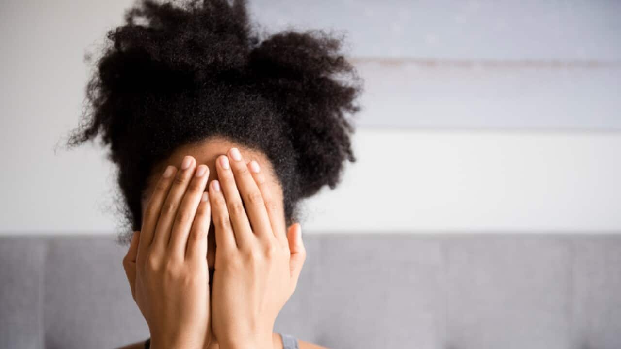 Woman covering face with hands