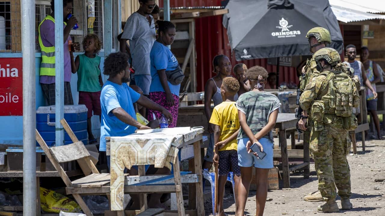 Australian Army soldiers talk with local citizens
