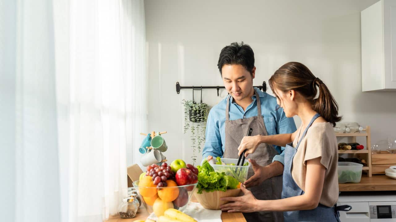 attractive-asian-man-and-woman-cooking-green-salad-2023-11-27-05-01-49-utc.jpg