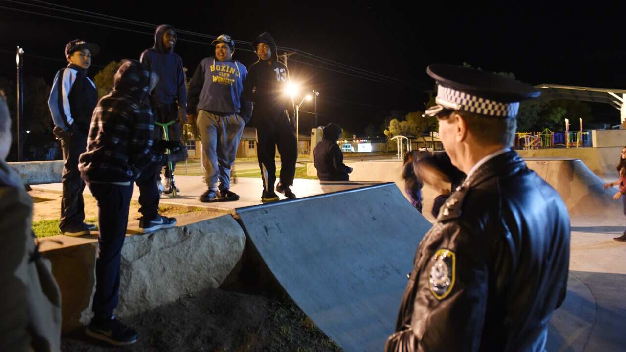 NSW Police officers talk to young Aboriginal people.
