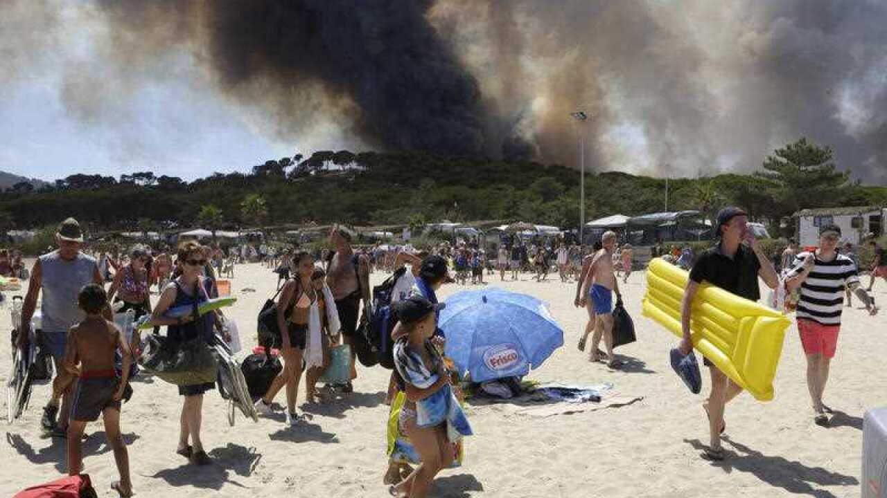 Sunbathers are being evacuated from the beach in Le Lavandou, French Riviera