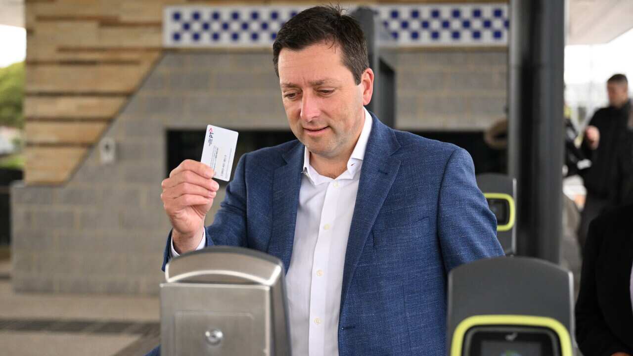 Victorian Opposition leader Matthew Guy uses a Myki card at a train station