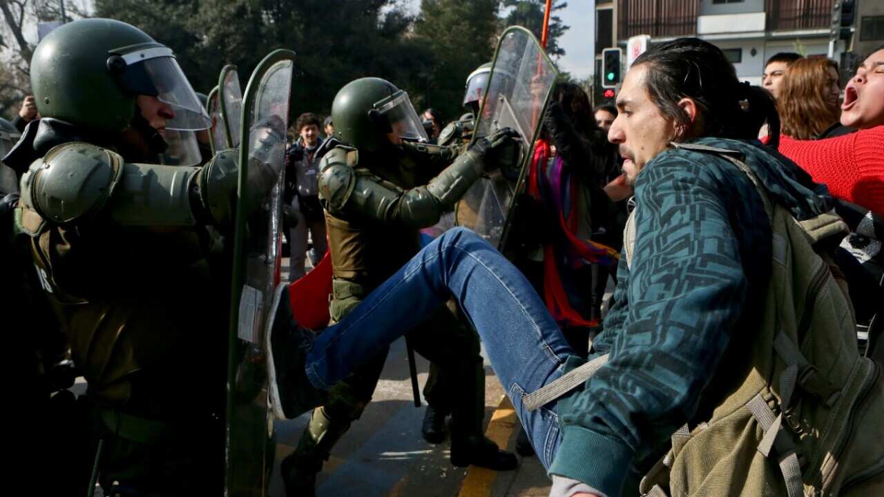People protesting the self-proclaimed "Bus of freedom," which rejects transgender children in schools, clash with police in downtown Santiago, Chile