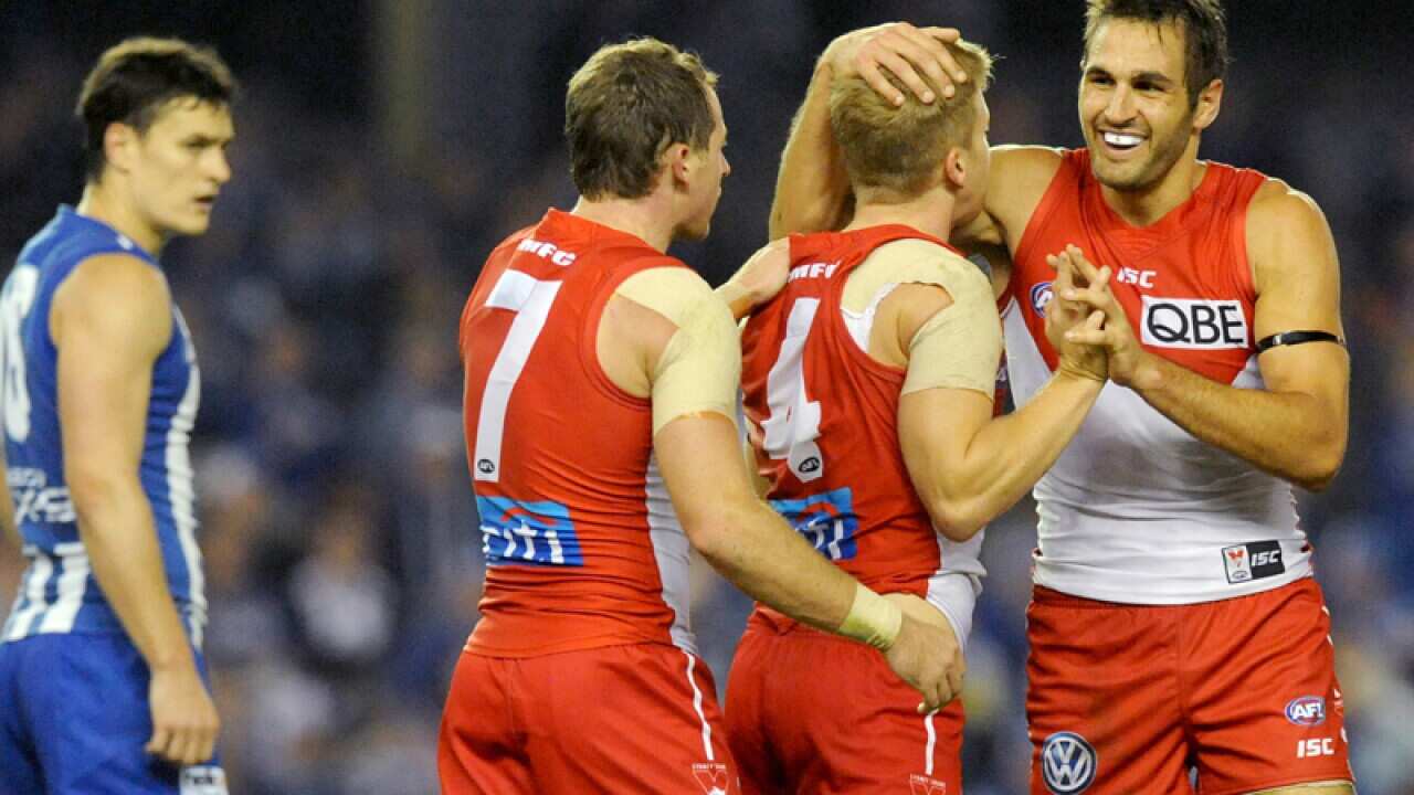 Swans captain Josh Kennedy (R) celebrates after scoring a goal