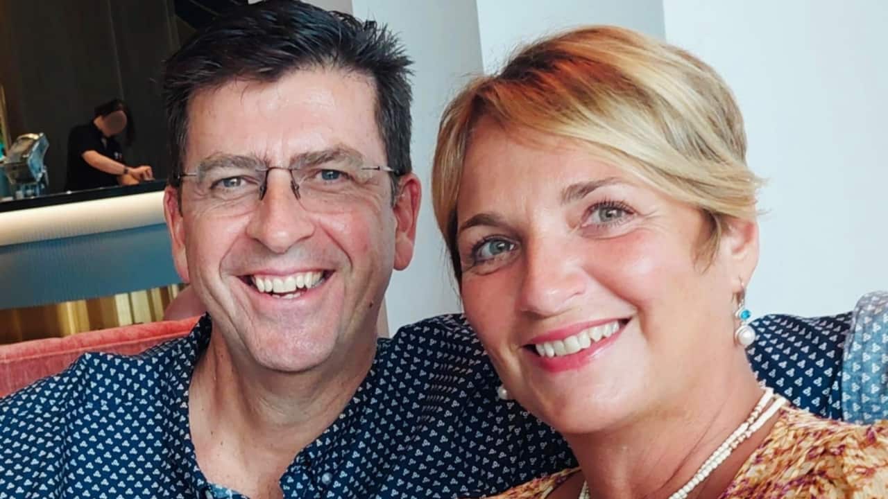 a middle aged couple smiling together in a restaurant