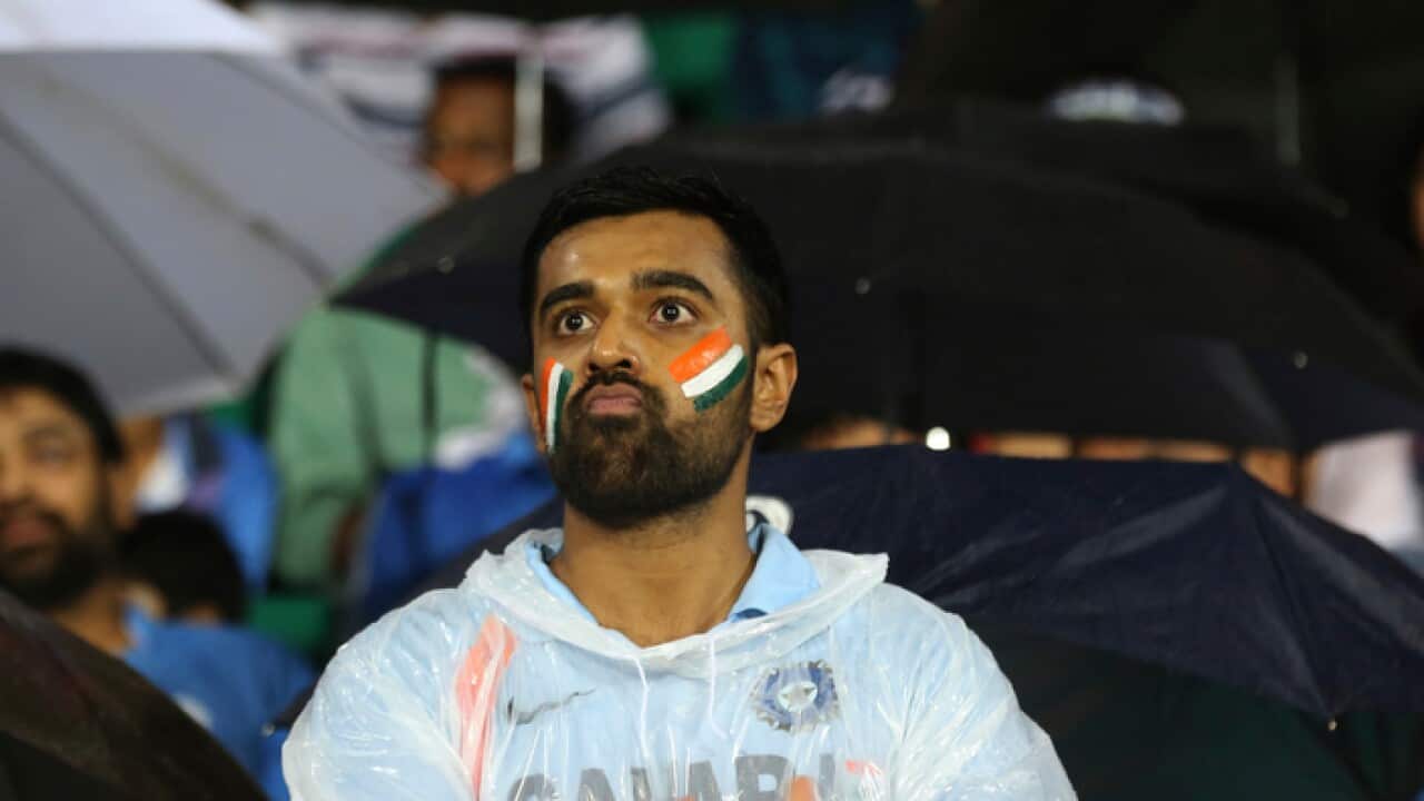 An Indian cricket fan reacts as rain delayed the start of the third Twenty20 international cricket match between India and New Zealand in Thiruvananthapuram, India, Tuesday, Nov. 7, 2017. (AP Photo/Aijaz Rahi)