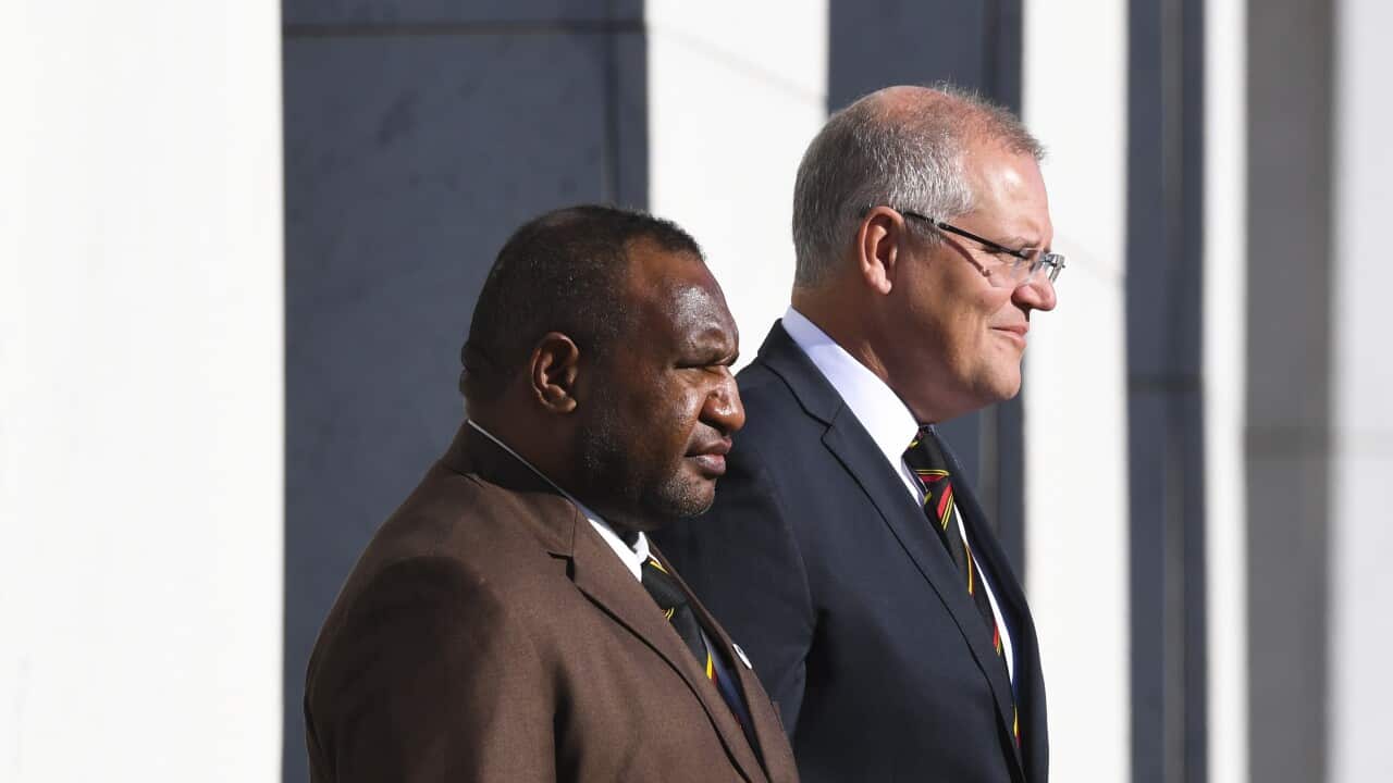 Prime Minister of Papua New Guinea James Marape and Australian Prime Minister Scott Morrison inspect the guard of honour during the official welcome ceremony.