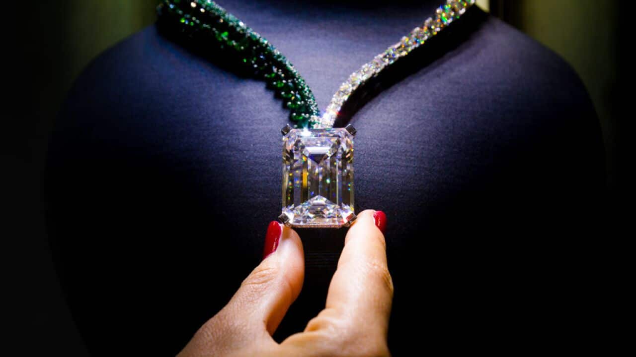 A woman handles a 404 carat-rough diamond, discovered in early 2016 that has been transformed by de GRISOGONO
