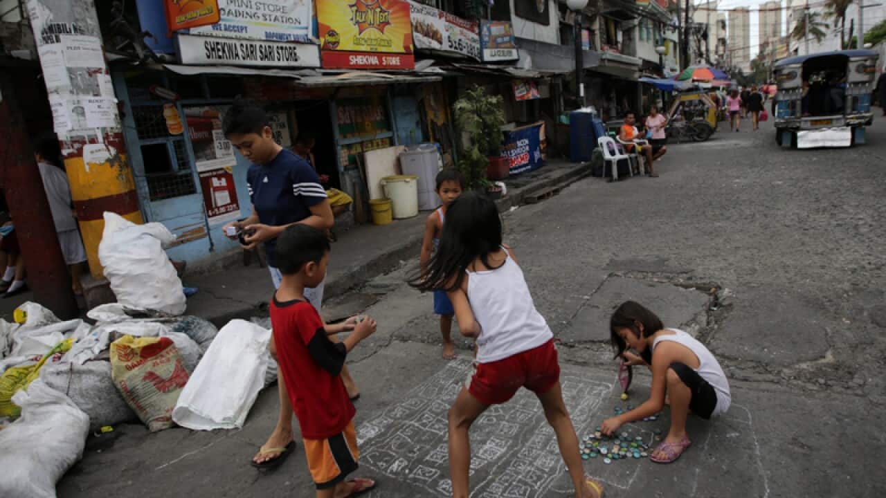 Young Filipino children enjoy street games, Philippines