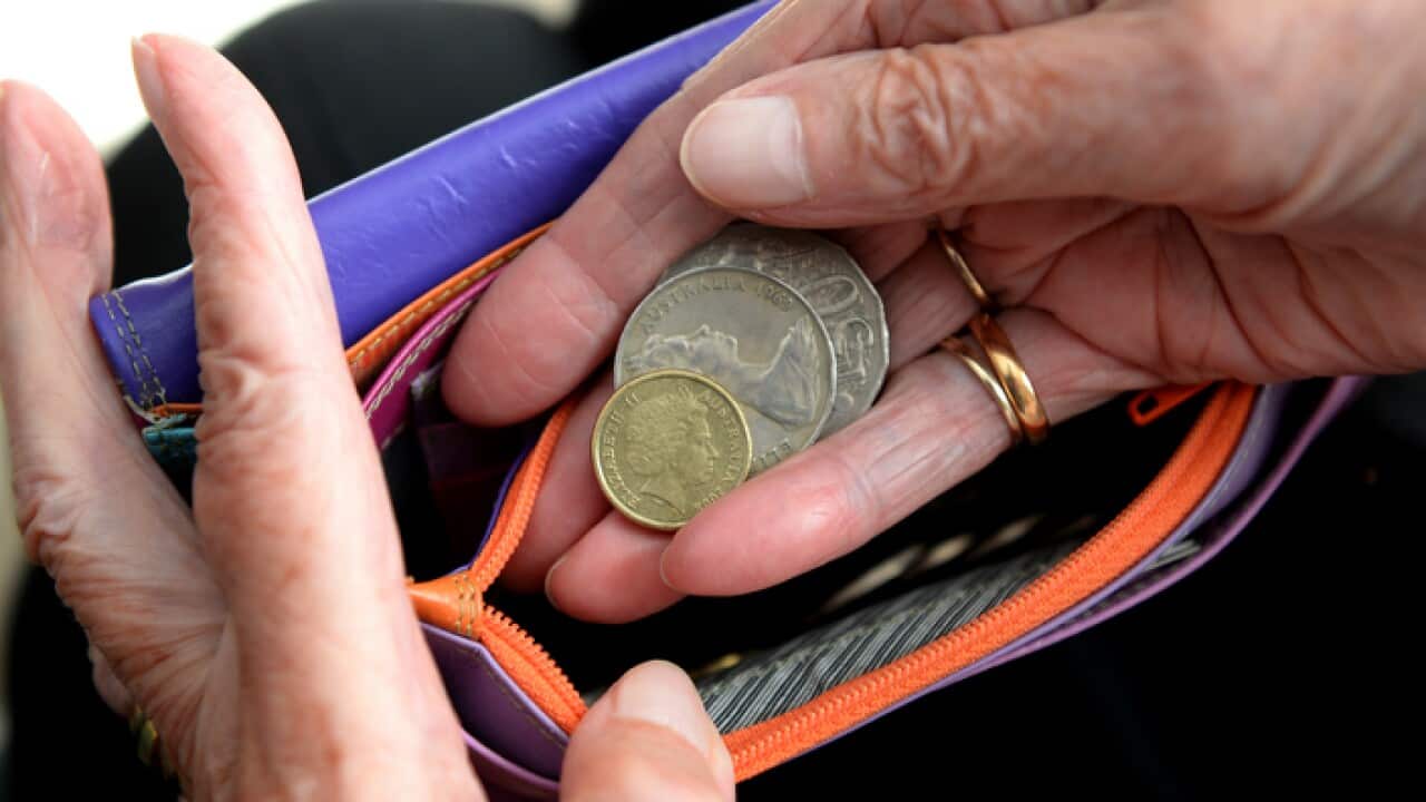 Money is taken out of a purse Canberra, April 8, 2014. Aged pensions are expected to be hit in the upcoming 2014 budget. (AAP Image/Alan Porritt) NO ARCHIVING