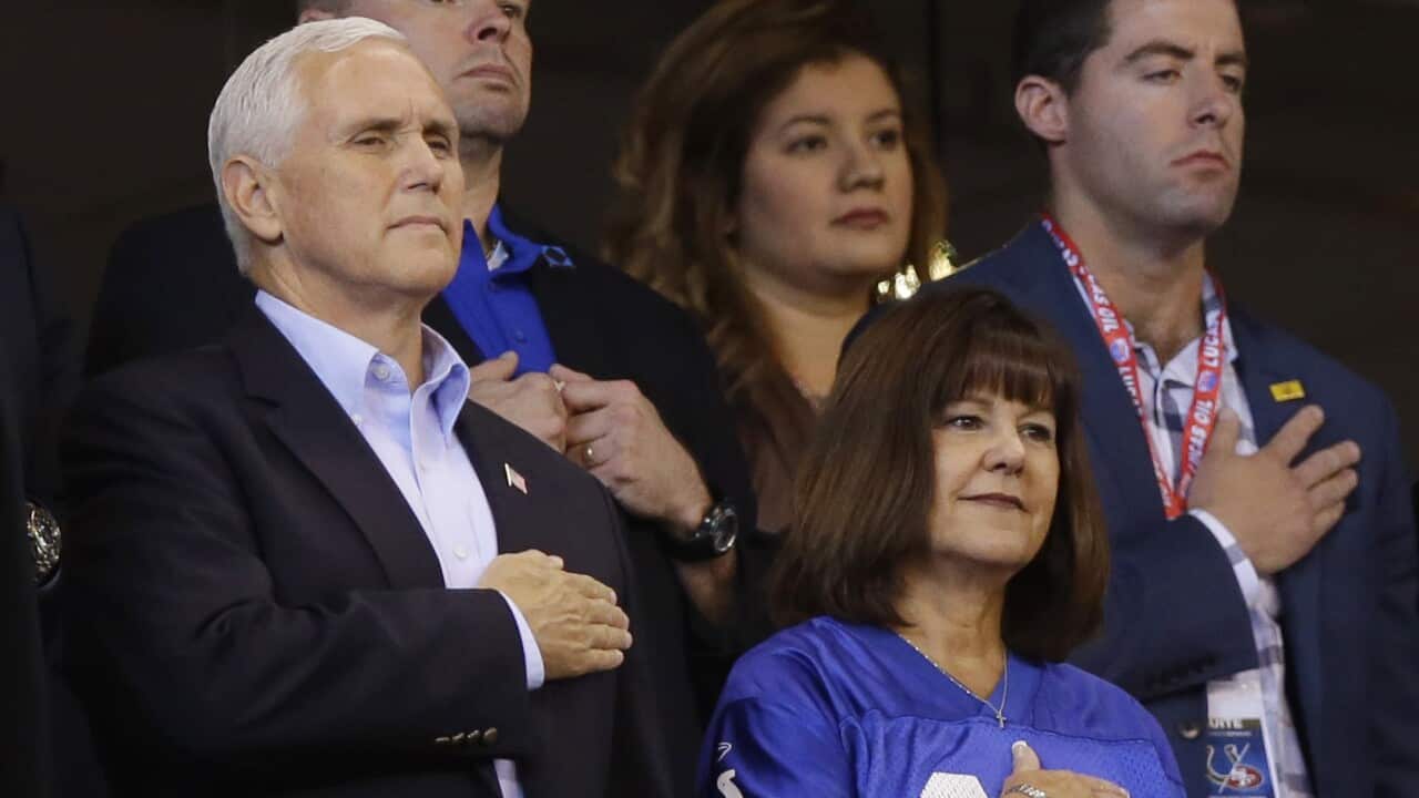 Vice President Mike Pence and his wife, Karen, stand during the playing of the national anthem before an NFL football game