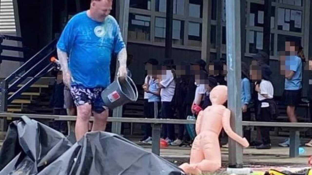 College principal Tim Cashmore with the inflatable sex doll on the school's muck-up day.