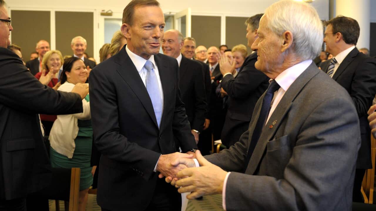 Tony Abbott greets Philip Ruddock.