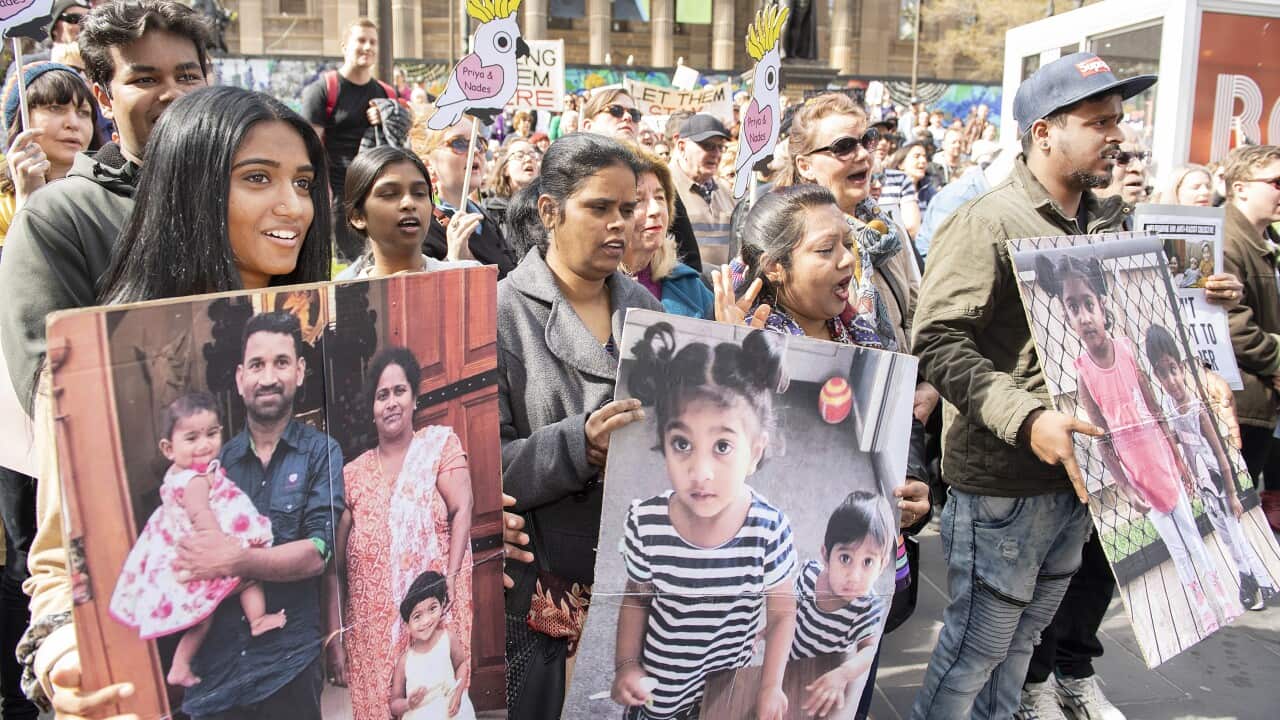 Supporters of Tamil asylum seekers Nadesalingam, Priya and their Australian-born children Kopika and Tharunicaa are seen at a rally outside the State Library of Victoria, Melbourne, Sunday, September 1, 2019. (AAP Image/Ellen Smith) NO ARCHIVING