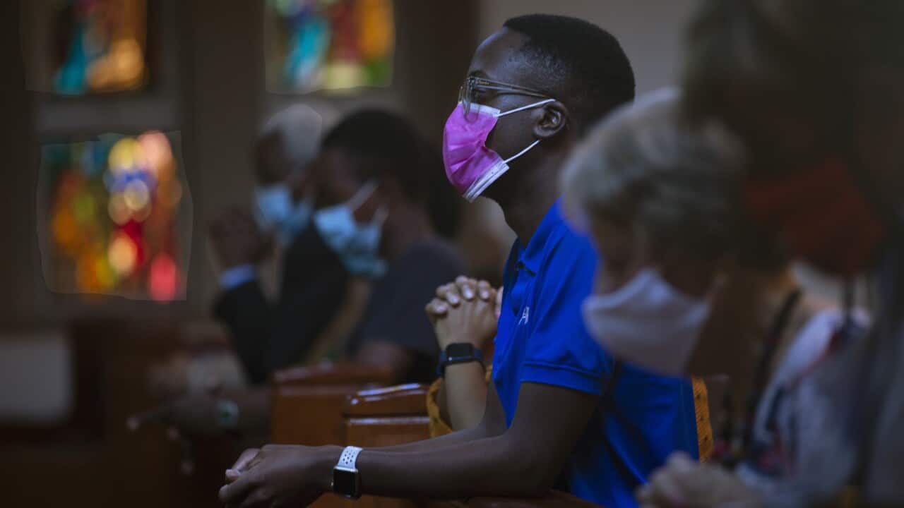 People wear face masks as they attend Easter Mass at the Catholic Church in Rosebank, Johannesburg