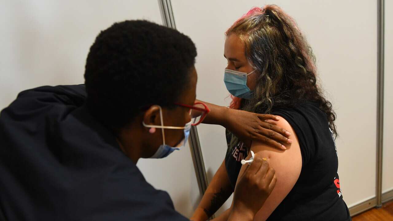 Paramedic Rhiannon Gallatly receives an AstraZeneca COVID-19 vaccination in Melbourne