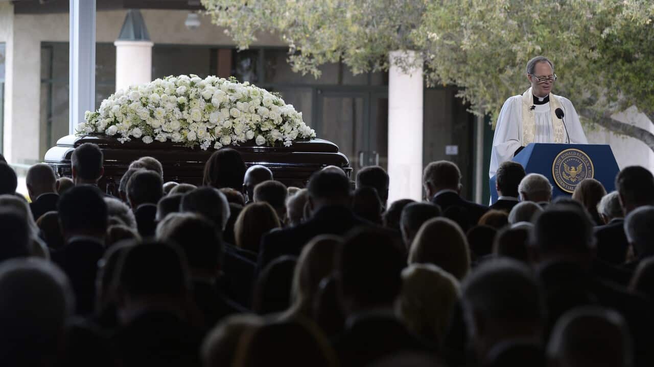 Reverend Stuart A. Kenworthy says a prayer next to the casket of former US First Lady Nancy Reagan during her funeral at the Ronald Reagan Presidential Library.
