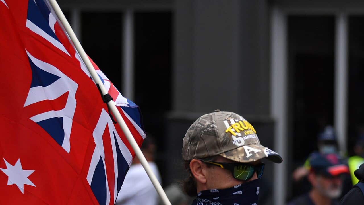 People participate in the Eureka Freedom Rally anti-vaccination and anti-mandatory vaccination protest in Melbourne, Saturday, December 4, 2021. (AAP Image/Joel Carrett) NO ARCHIVING