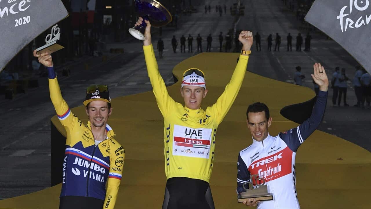 Tour de France winner Tadej Pogacar, second placed Primoz Roglic of Slovenia, and third placed Richie Porte of Australia, celebrate on the podium.