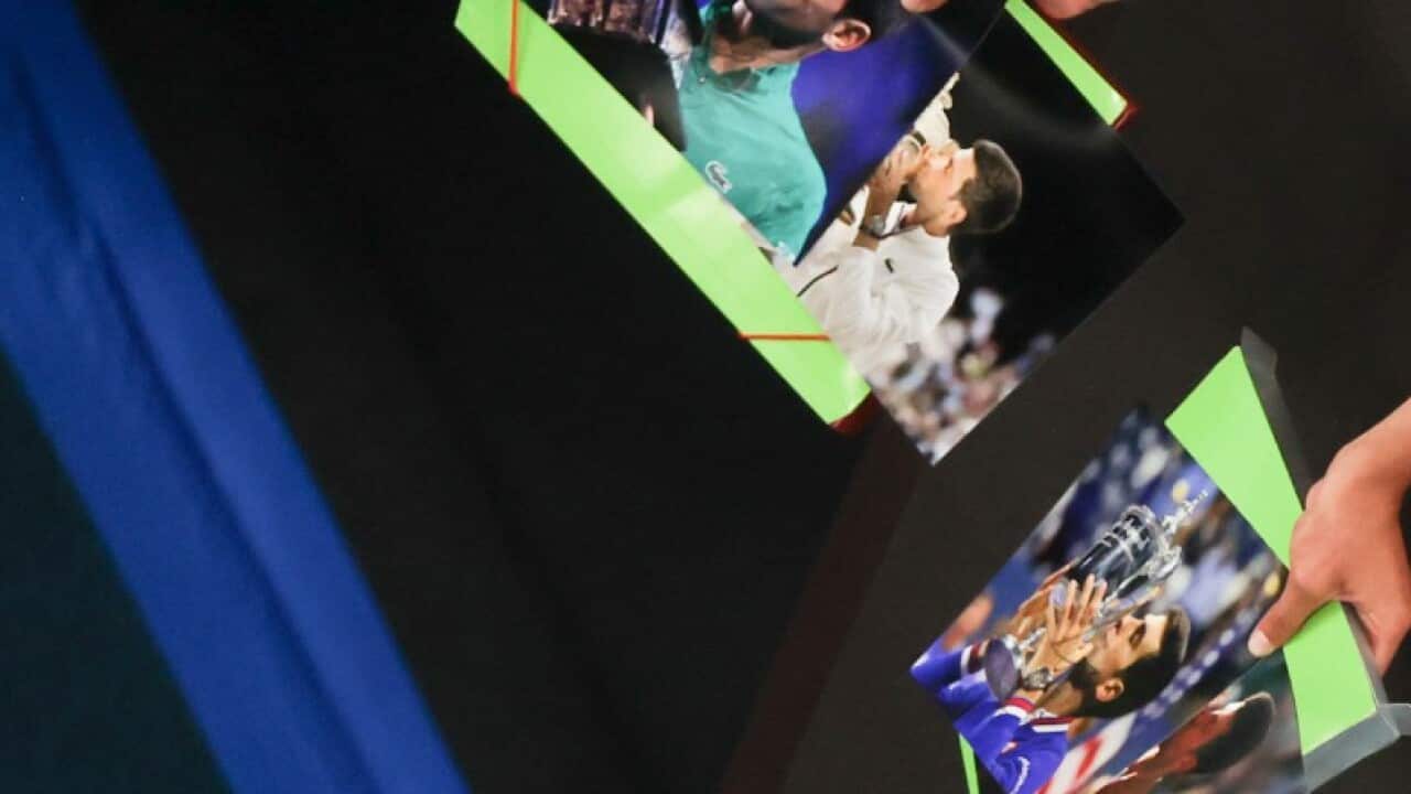 Serbia's Novak Djokovic signs autographs after defeating Russia's Aslan Karatsev in their semifinal match at the Australian Open tennis championship in Melbourne, Australia, Thursday, Feb. 18, 2021. AAP Image/AP Photo/Hamish Blair