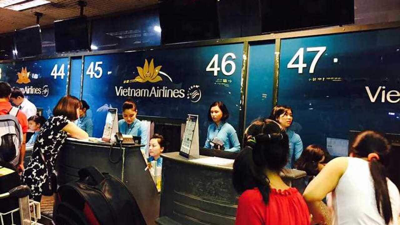 Passengers crowd at check-in counters at Noi Bai Airport in Hanoi, Vietnam