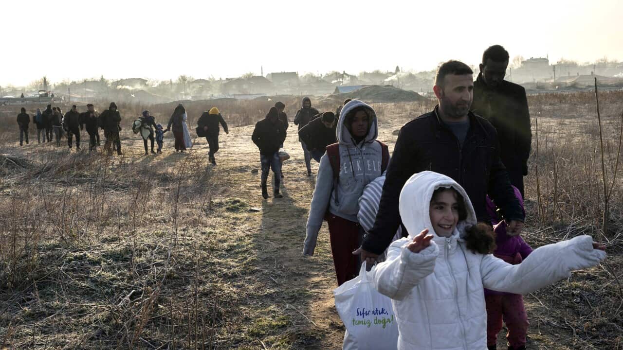 Refugees wait in front of the Greek border at Pazarkule gate, in Edirne, Turkey, on 1 March, 2020.