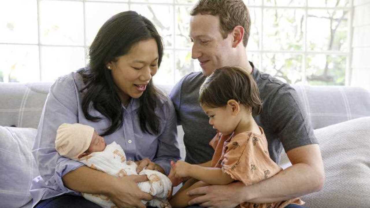 This photo provided Monday, Aug. 28, 2017, by Facebook, shows Facebook CEO Mark Zuckerberg with his wife, Priscilla Chan, and their new baby daughter August