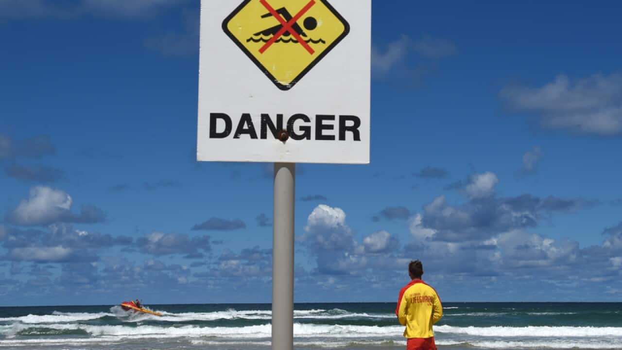 A surf rescue boat searches Shelly Beach in far northern NSW