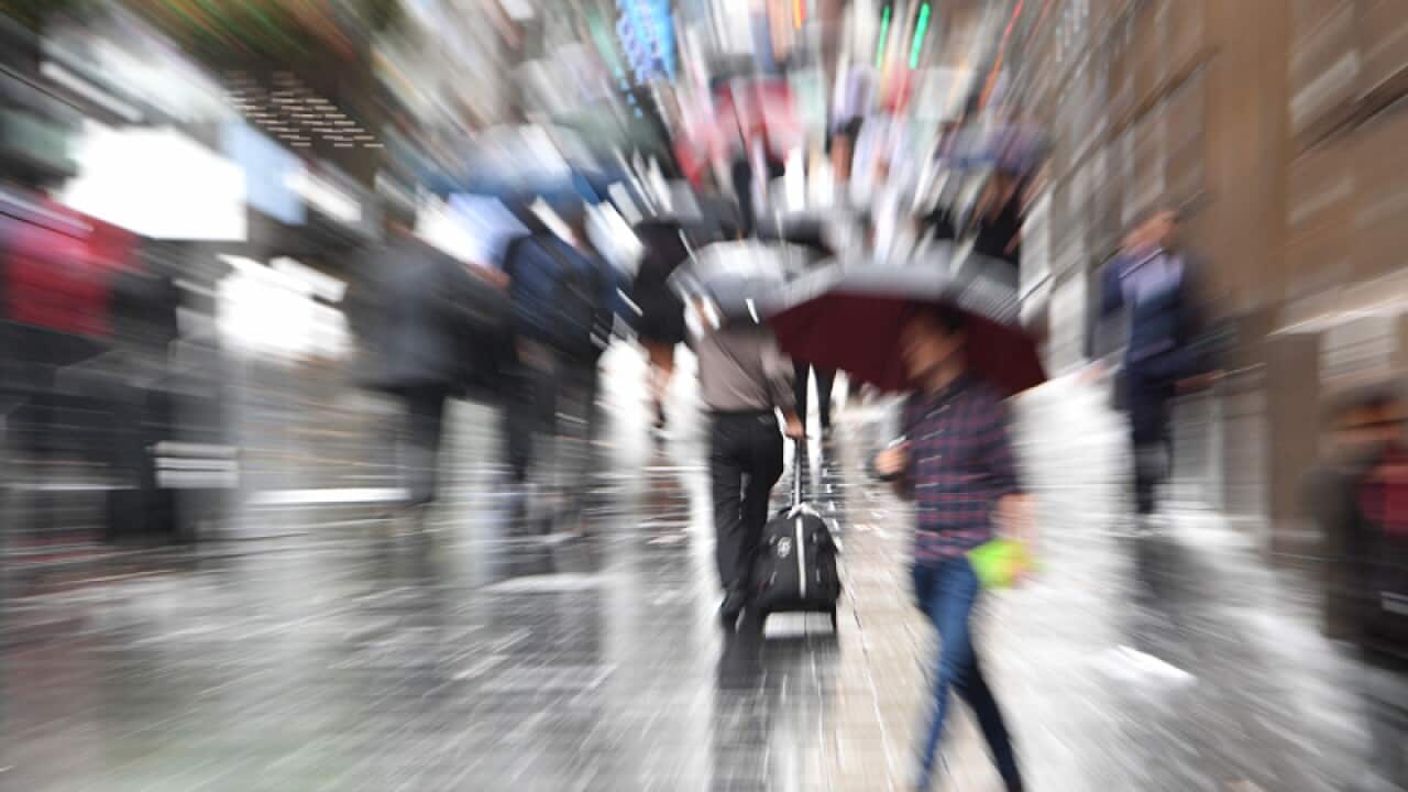 People are seen in the central business district in Sydney