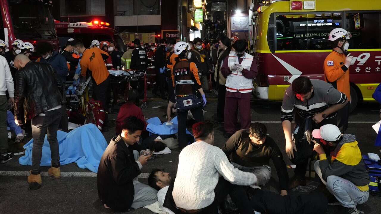 Rescue workers help injured people at the scene (AAP)