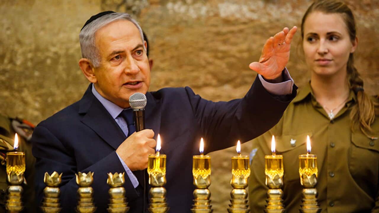 Israeli Prime Minister Benjamin Netanyahu speaks during a menorah-lighting ceremony