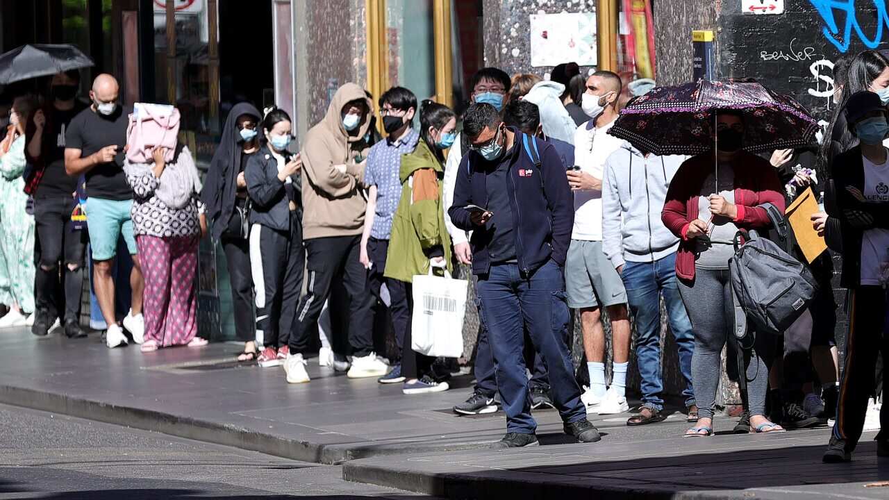 People are seen in a queue at the Russell Street testing clinic in Melbourne, Monday, December 20, 2021