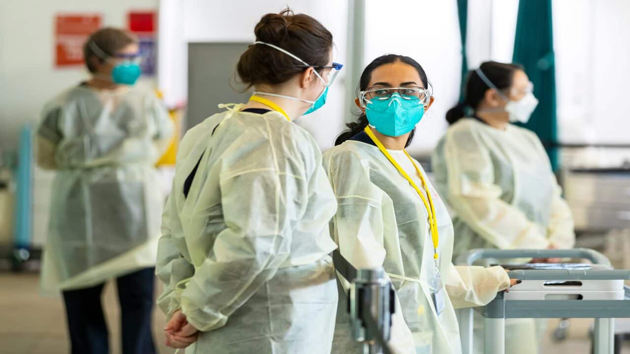 Health workers are seen at the Melbourne Museum in Melbourne, Monday, 6 September, 2021.