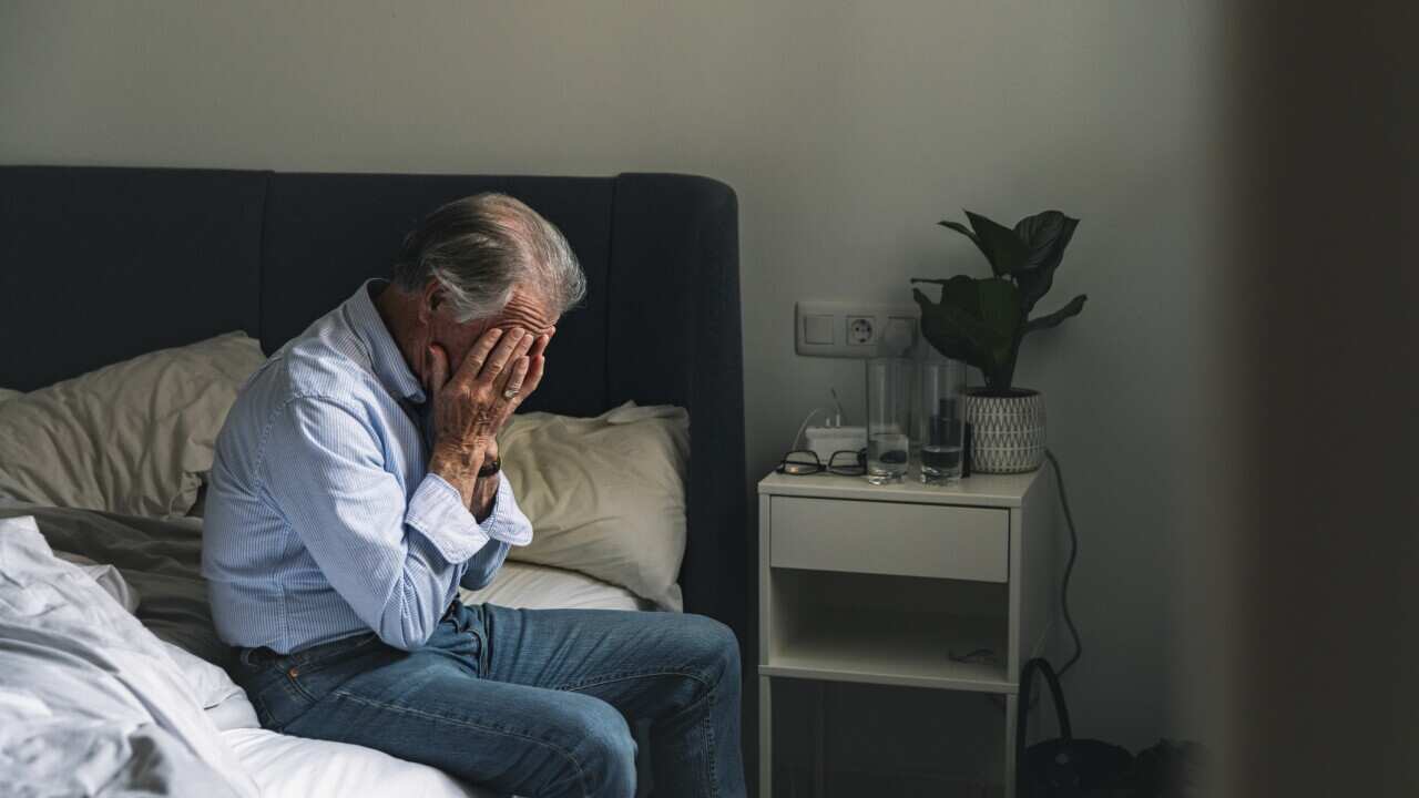 Senior male sitting on his bed - negative emotion