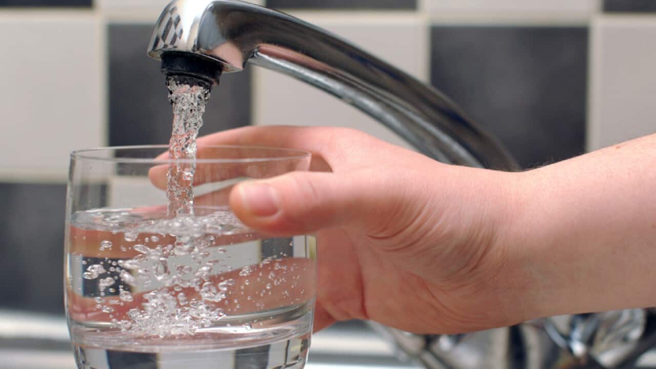 Tap water being poured from a tap in to a glass.