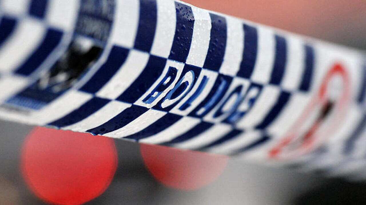 Police tape restricts access to a crime scene north of Sydney, Friday, July 24, 2015. (AAP Image/Joel Carrett) NO ARCHIVING