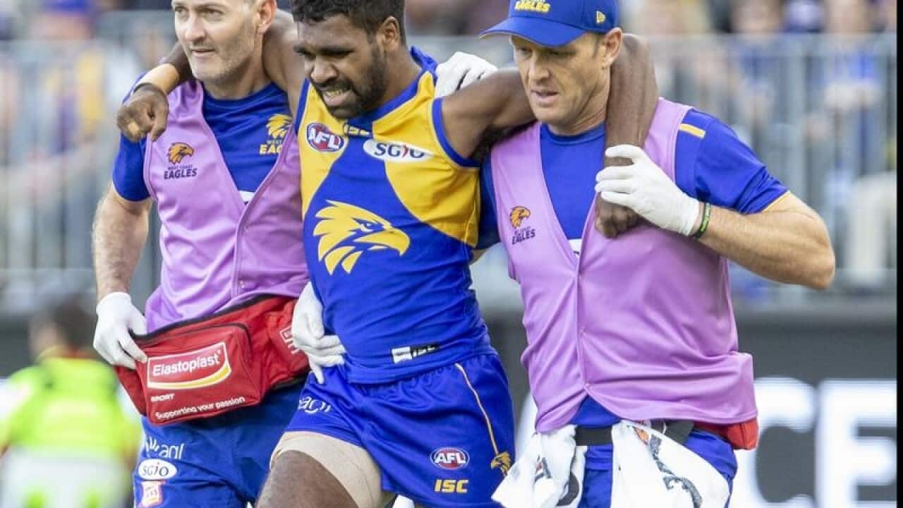 West Coast's Liam Ryan is carried off by trainers.