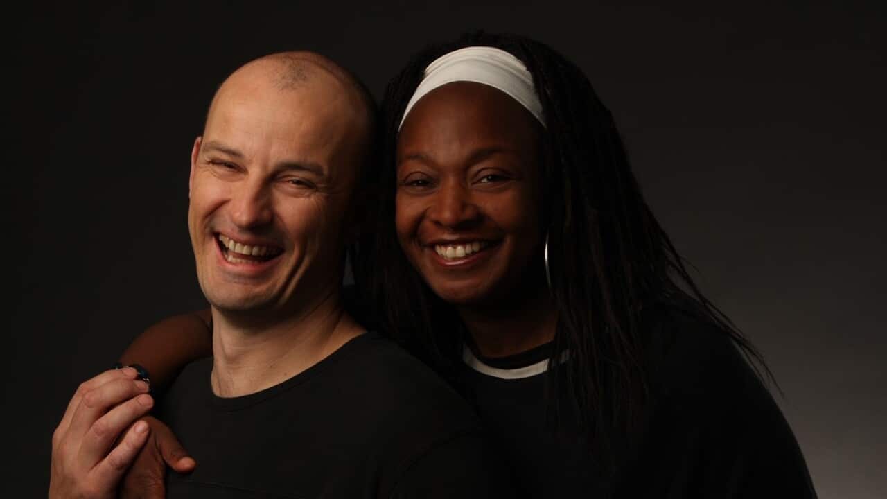 Man and women smiling.