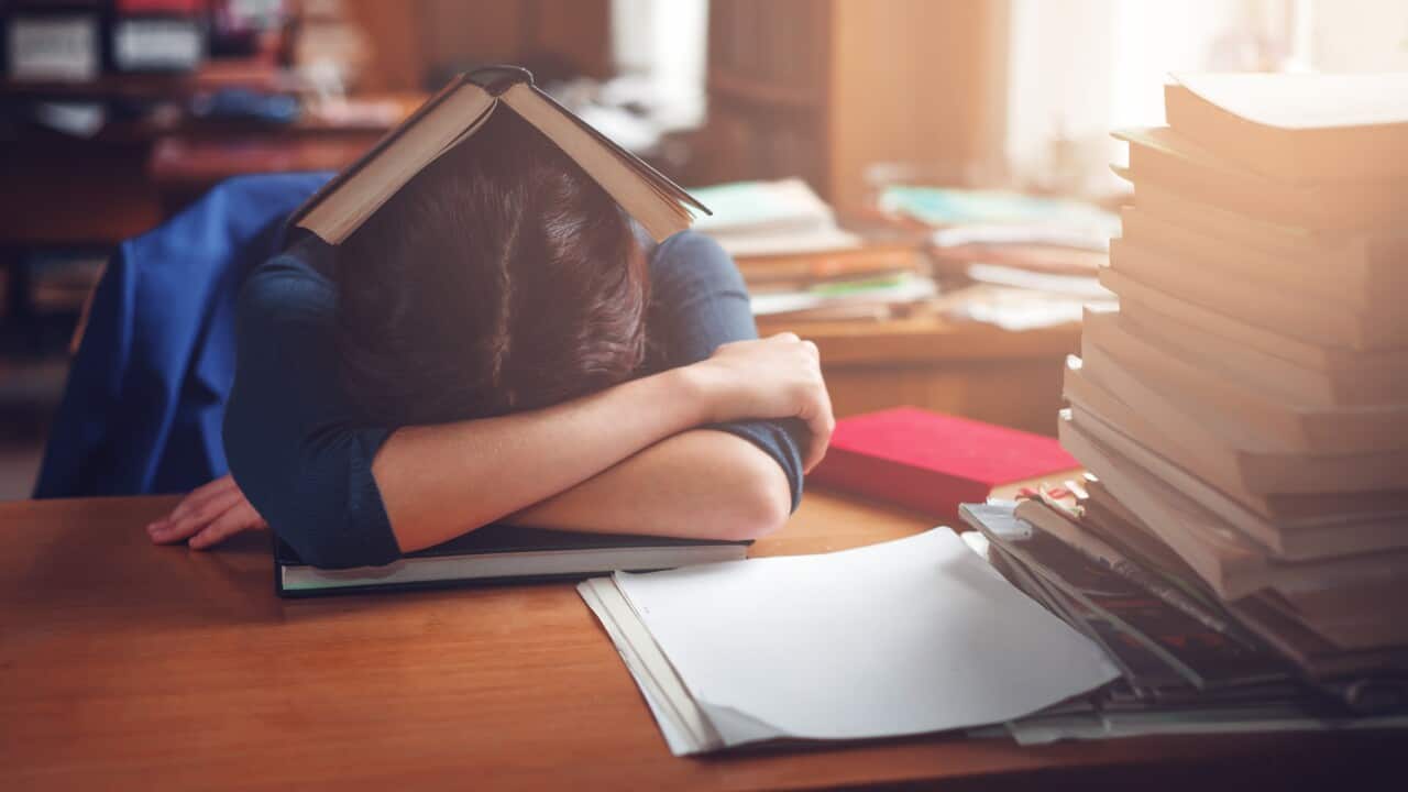 Woman sleeping with a book on her head.