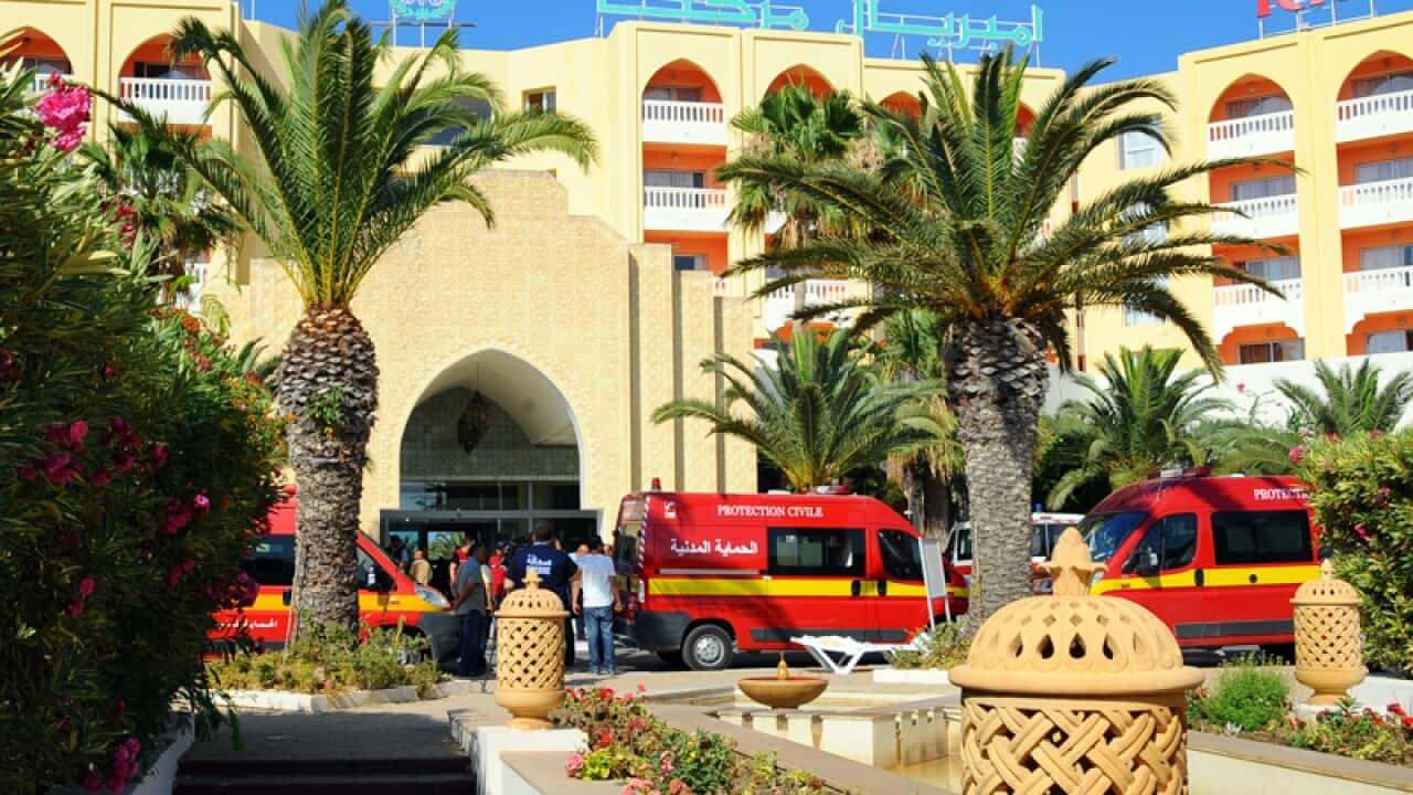 Injured people are treated where an attack took place in Tunisia