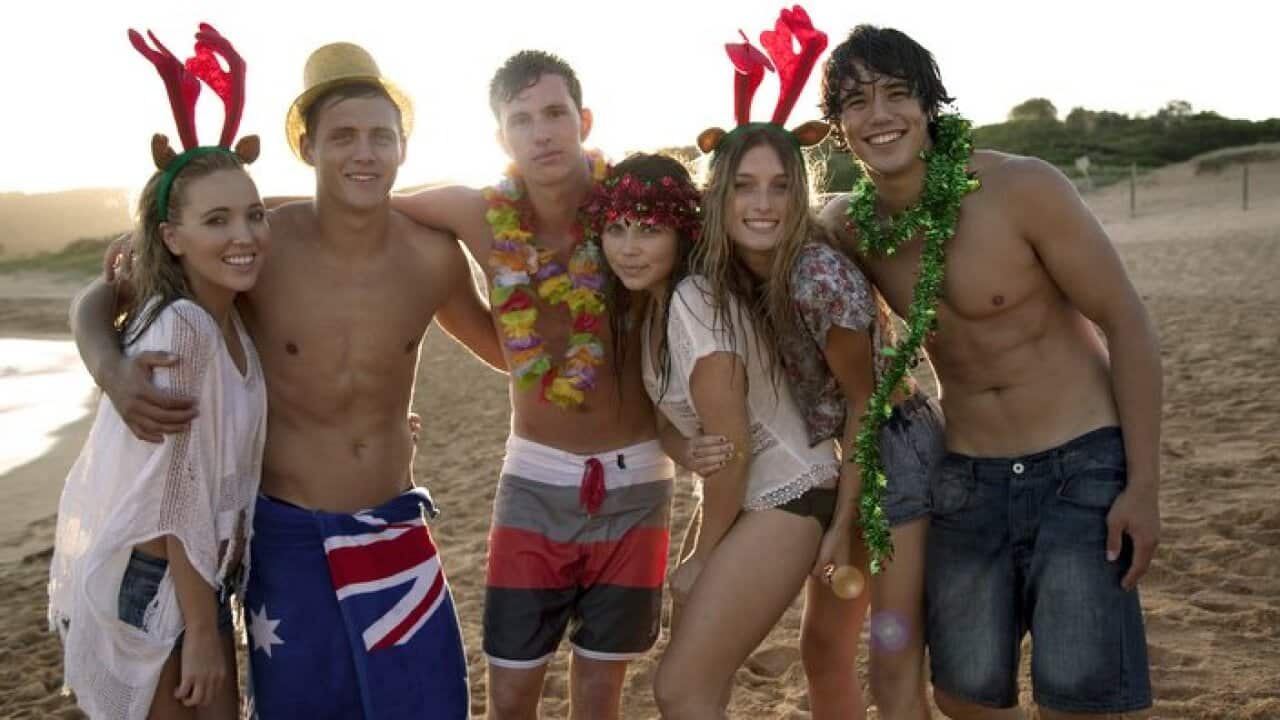 Group of teenagers on the beach at Christmas