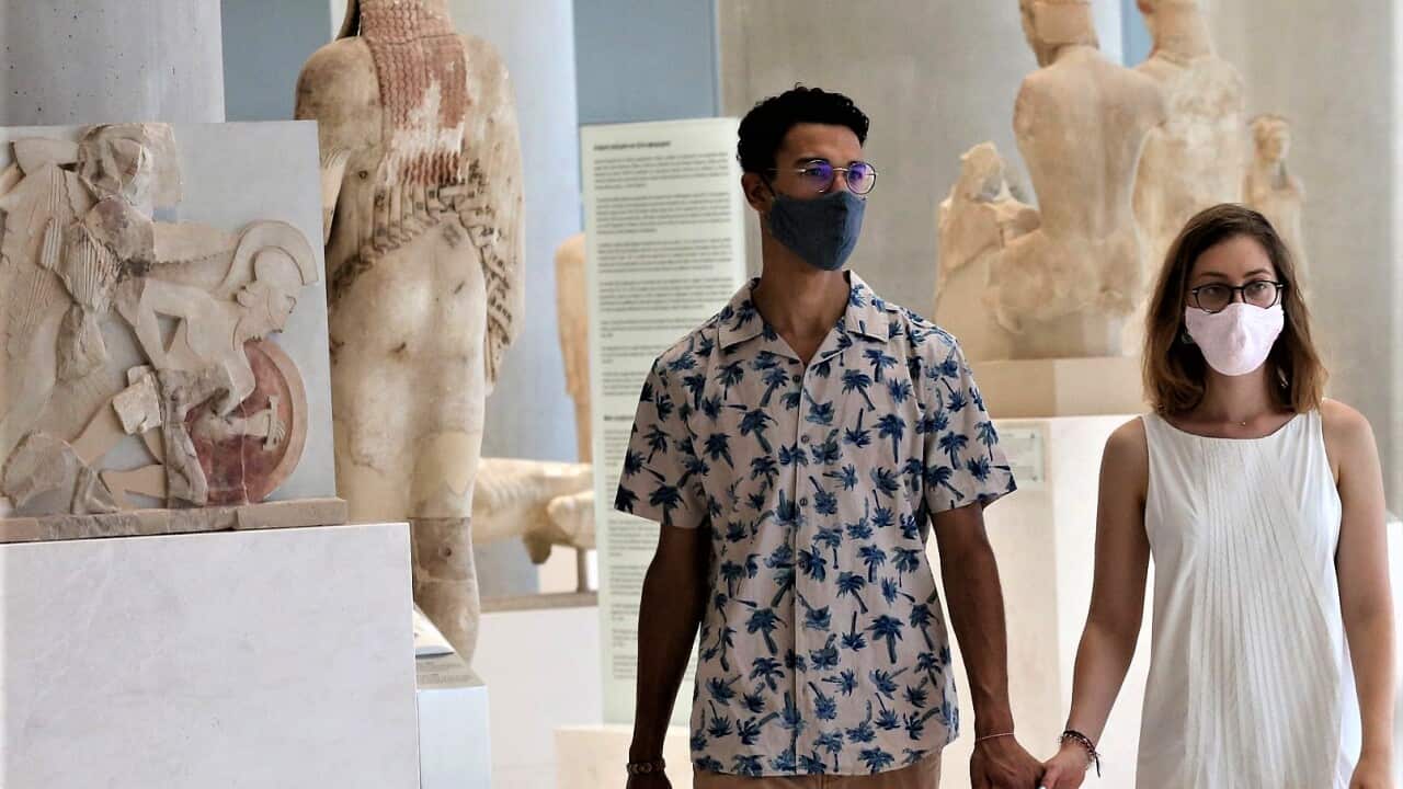 Visitors wear face masks as they view exhibits at the Acropolis Museum in Athens.