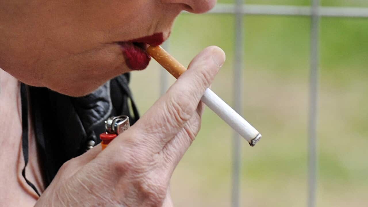A woman smokes a cigarette in Brisbane