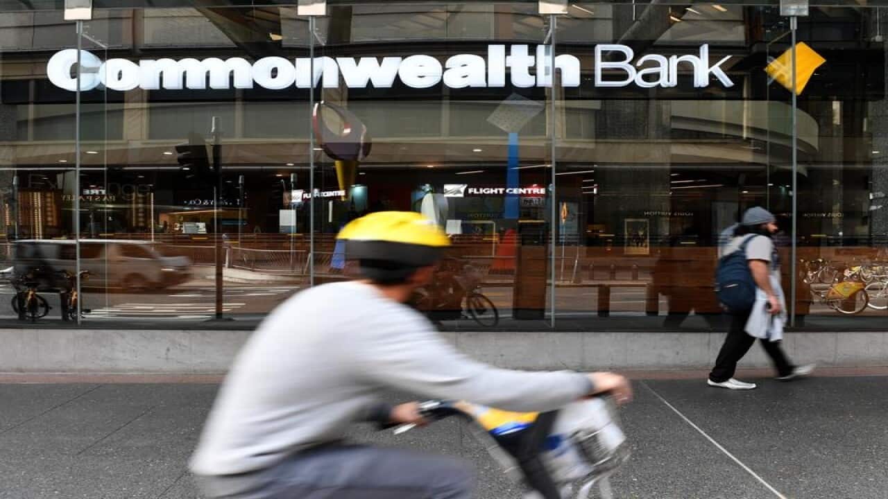 People walk by a Commonwealth Bank