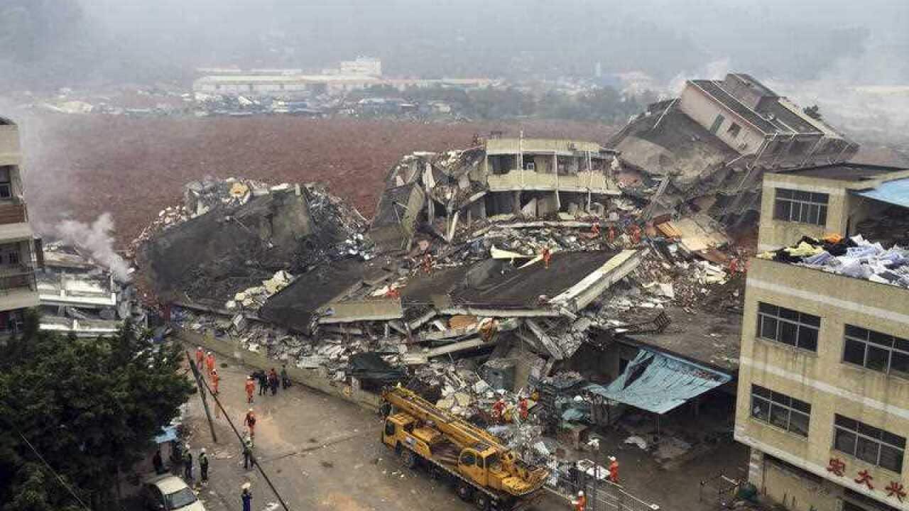Rescuers search for survivors amongst collapsed buildings after a landslide in Shenzhen, in south China's Guangdong province