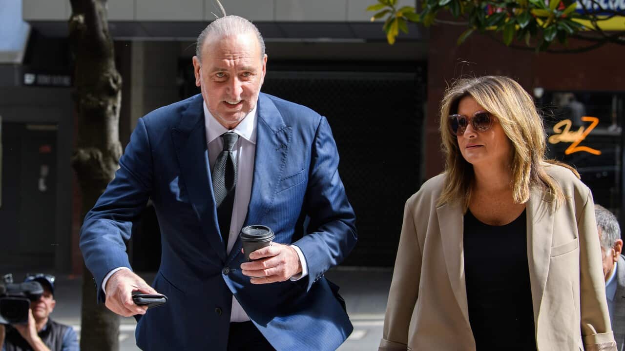 Brian Houston and his wife Bobbie walking up stairs outside