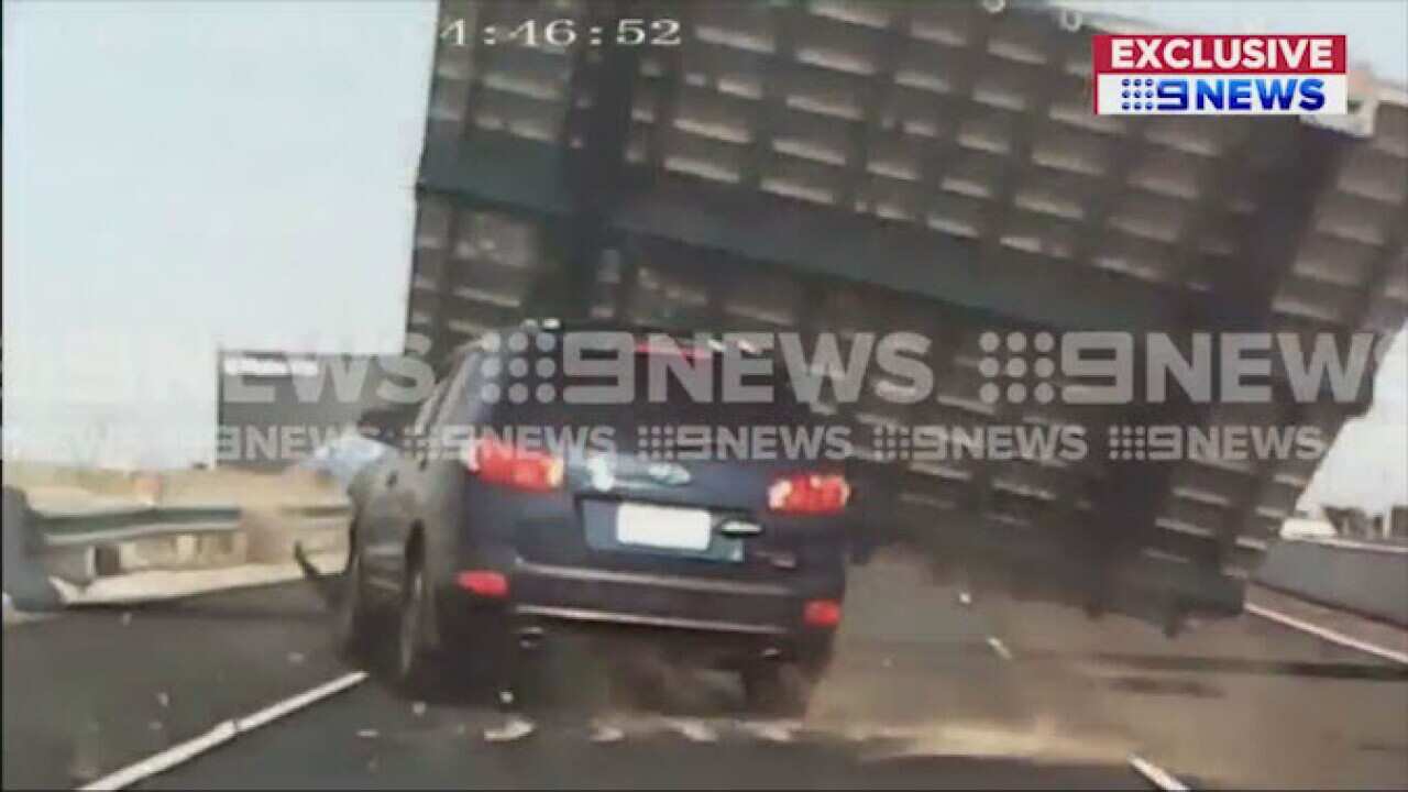 Freeway sign falls on car, injuring woman