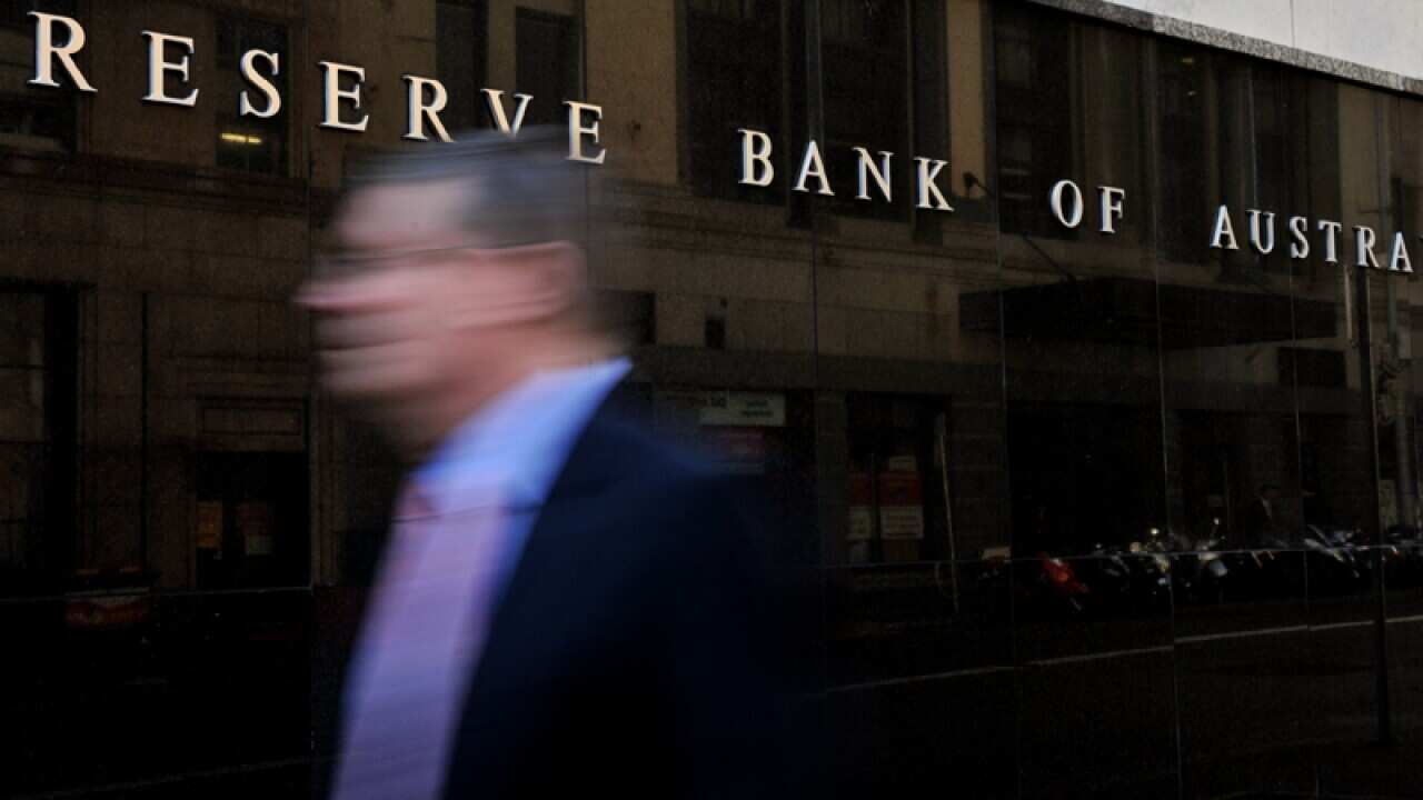 A pedestrian walks past the Reserve Bank of Australia