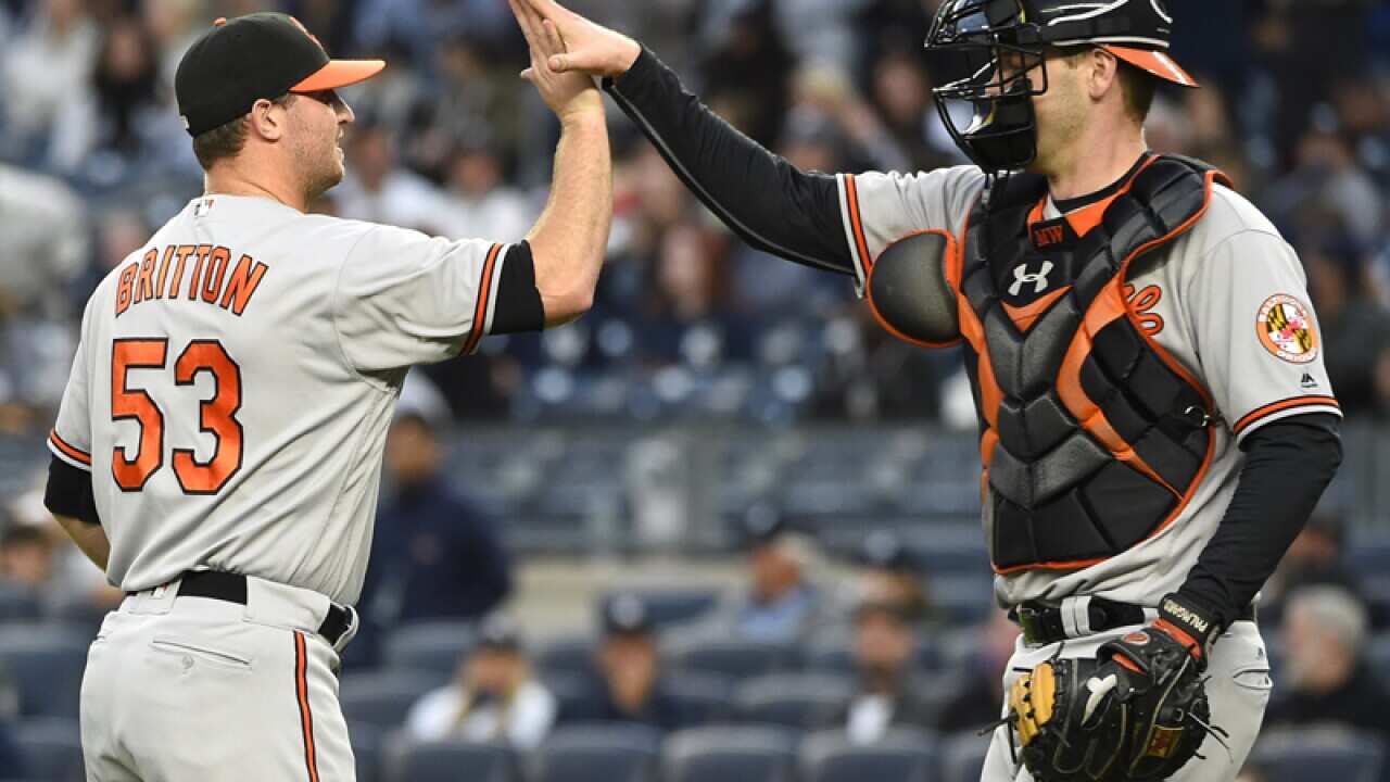 Baltimore's Zach Britton (53) and Matt Wieters