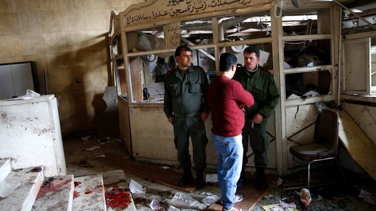 Security personnel at the scene of a suicide bombing in Damascus